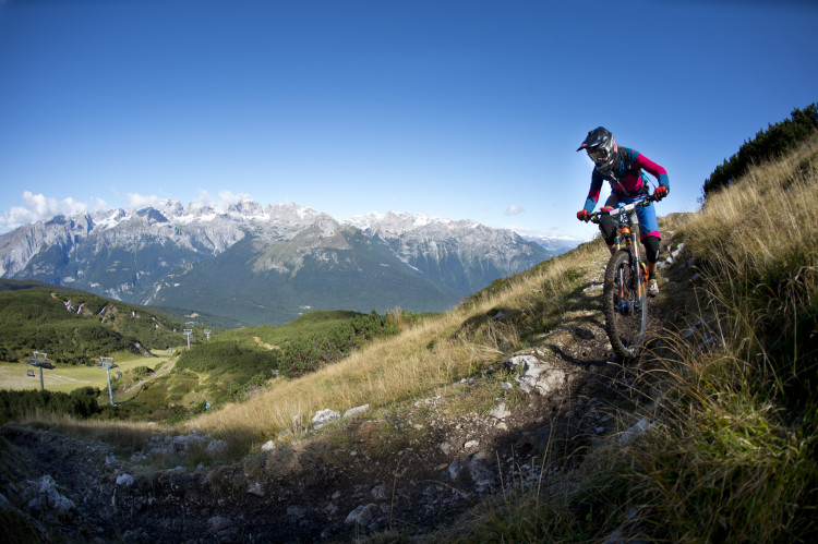 Franziska Meyer of GER in front of the impressive panorama of the Brenta mountains in the Dolomites. Stage 3 at the 4th stop of the European Enduro Series at Molveno-Paganella, Italy on September 06, 2015. Free image for editorial usage only: Photo by Manfred Stromberg